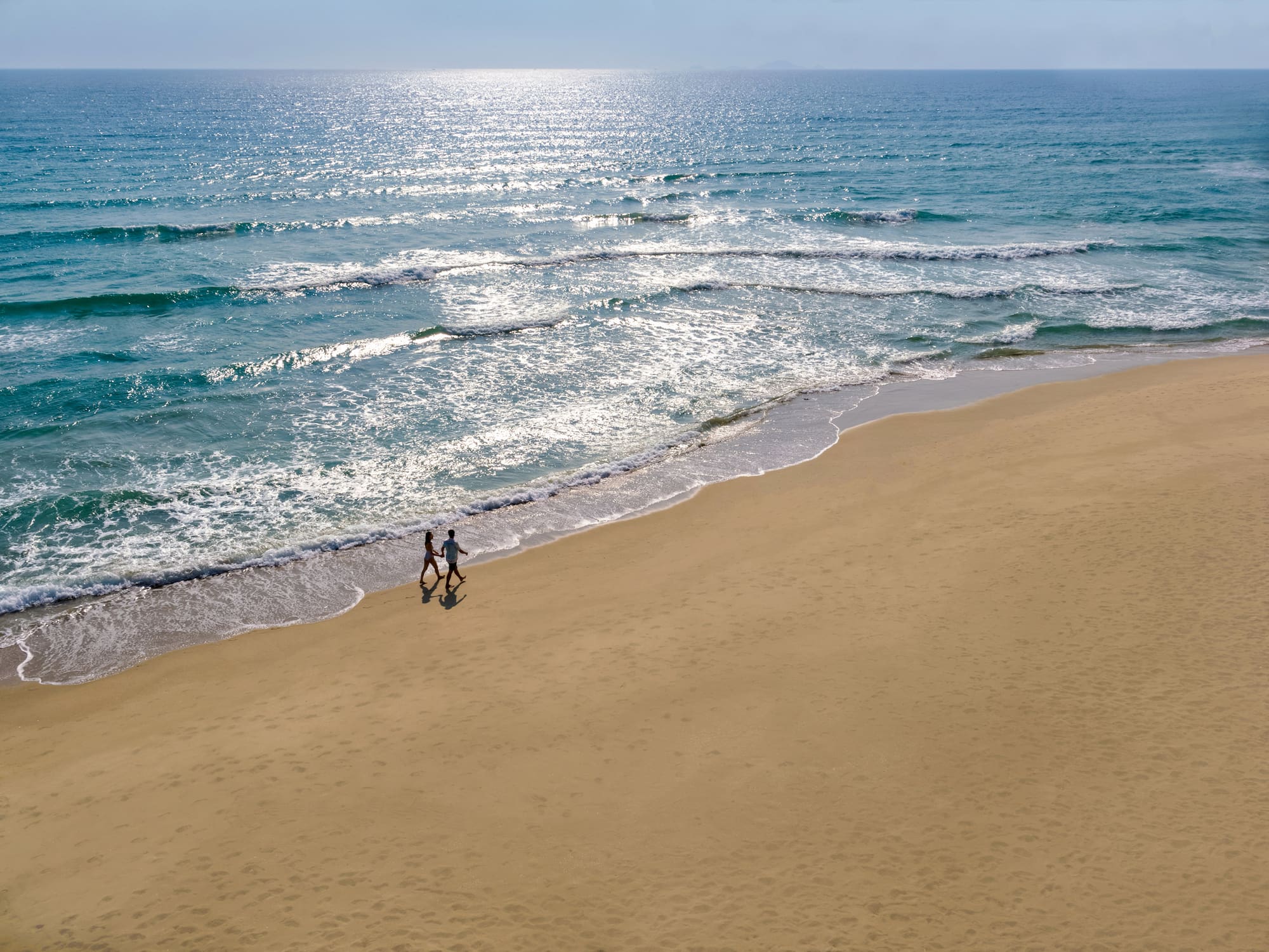 people walking on a beach