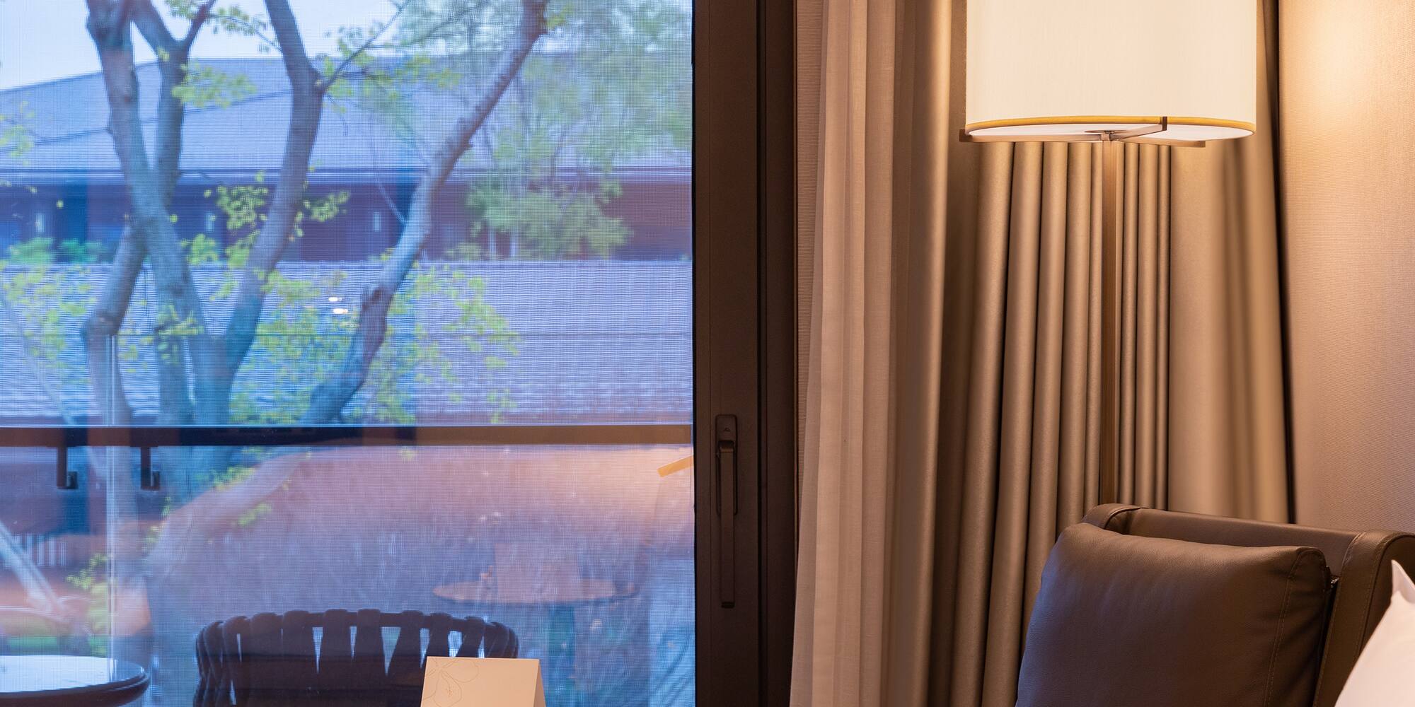 a room with a window and a chair and a table