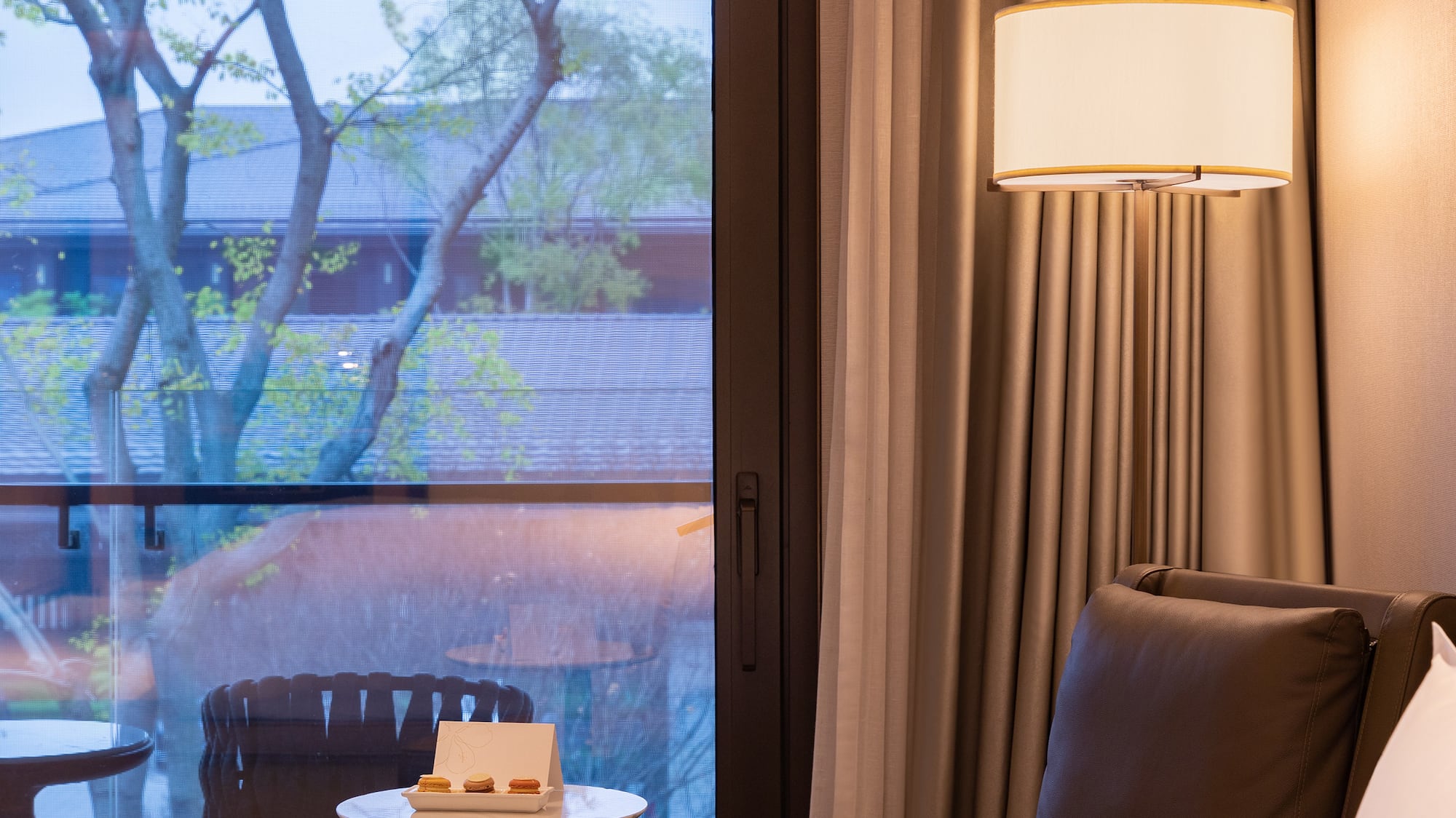 a room with a window and a chair and a table