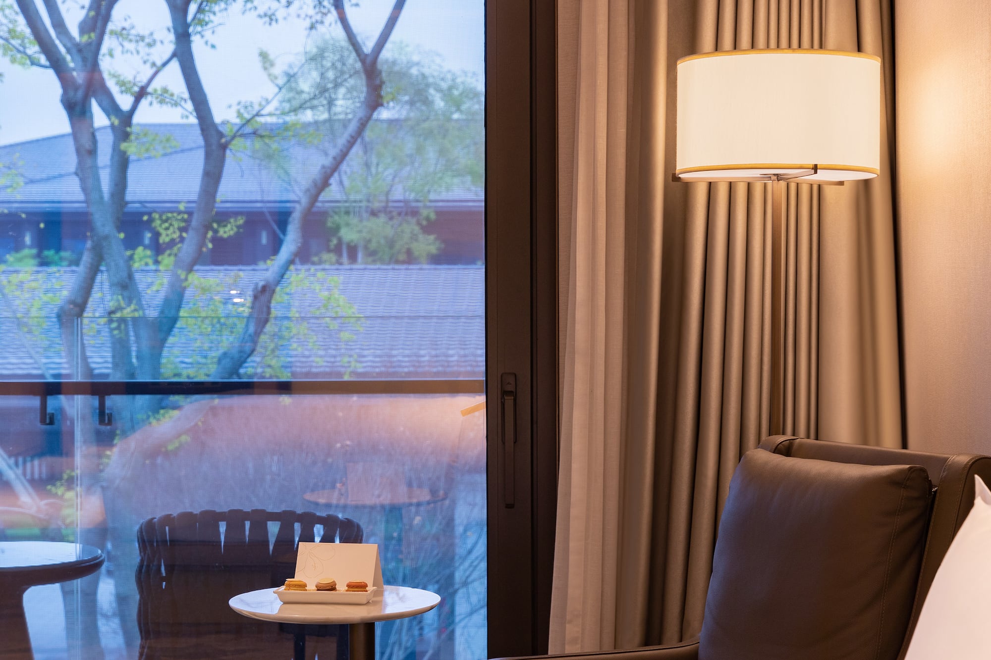 a room with a window and a chair and a table