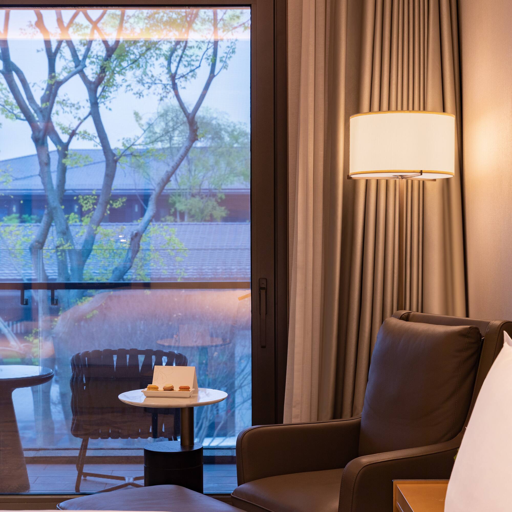 a room with a window and a chair and a table