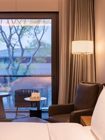 a room with a window and a chair and a table