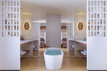 a bathroom with a tub and shelves