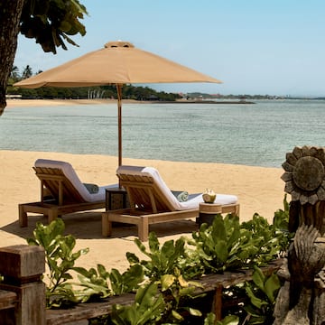 chairs on a beach with a umbrella