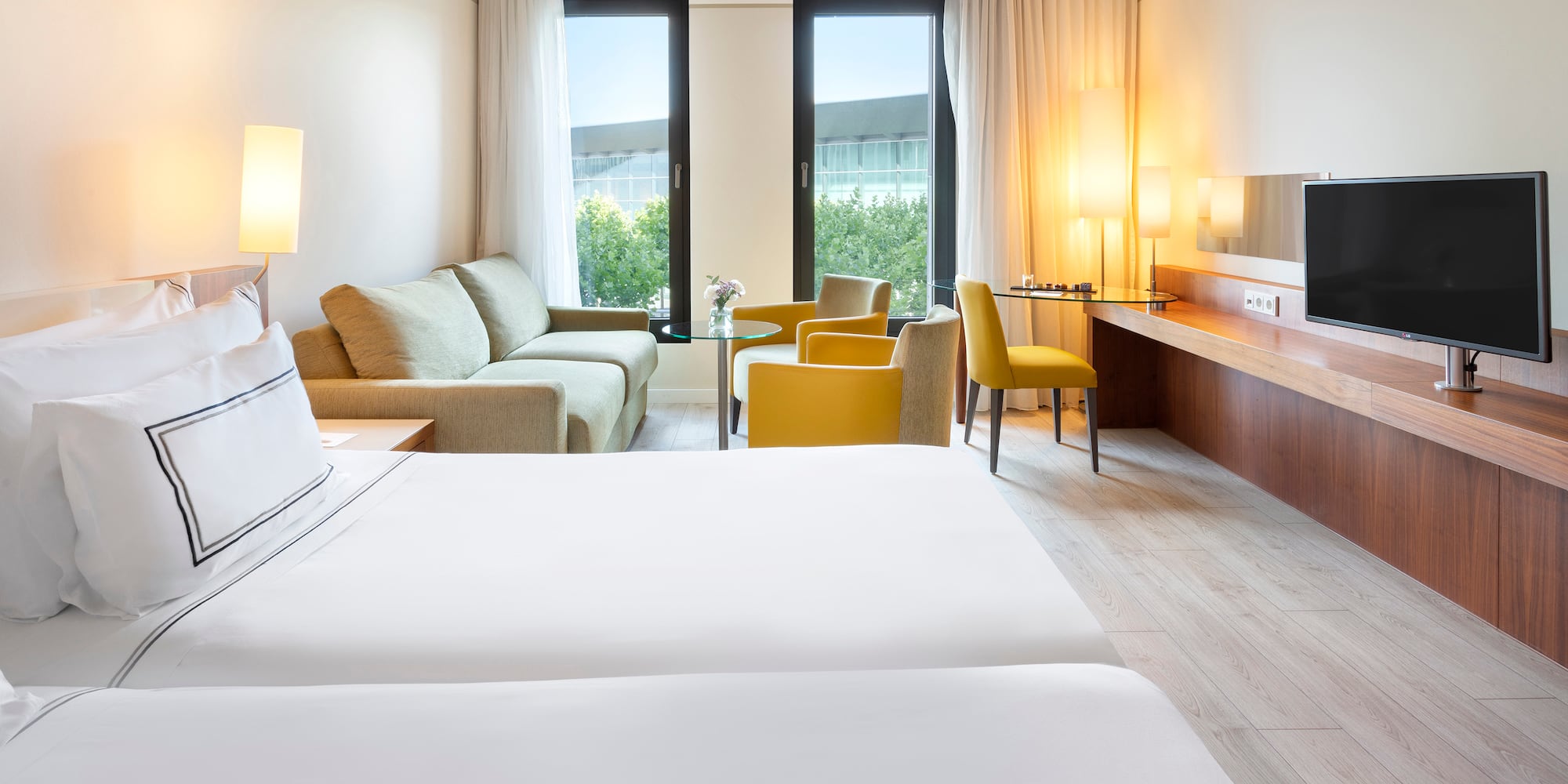 a room with two beds and a television