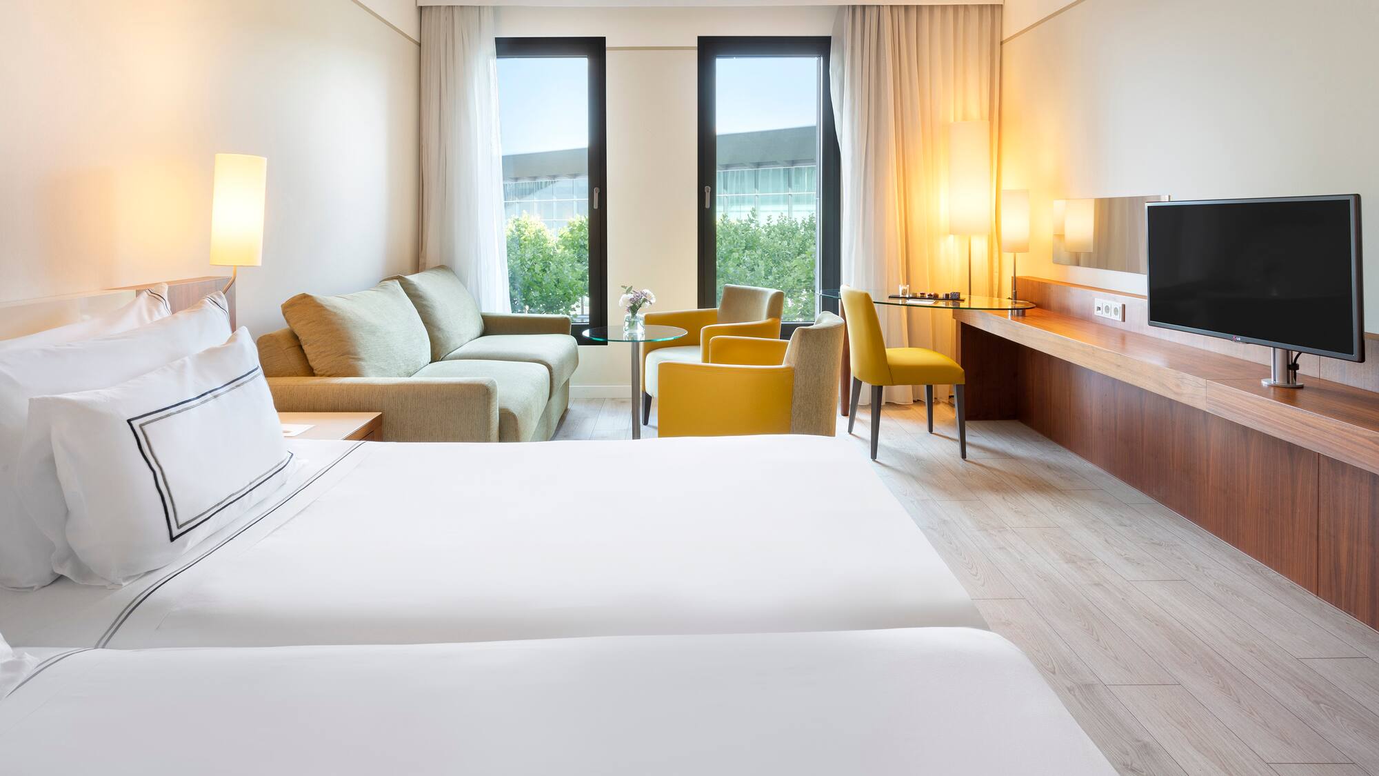 a room with two beds and a television