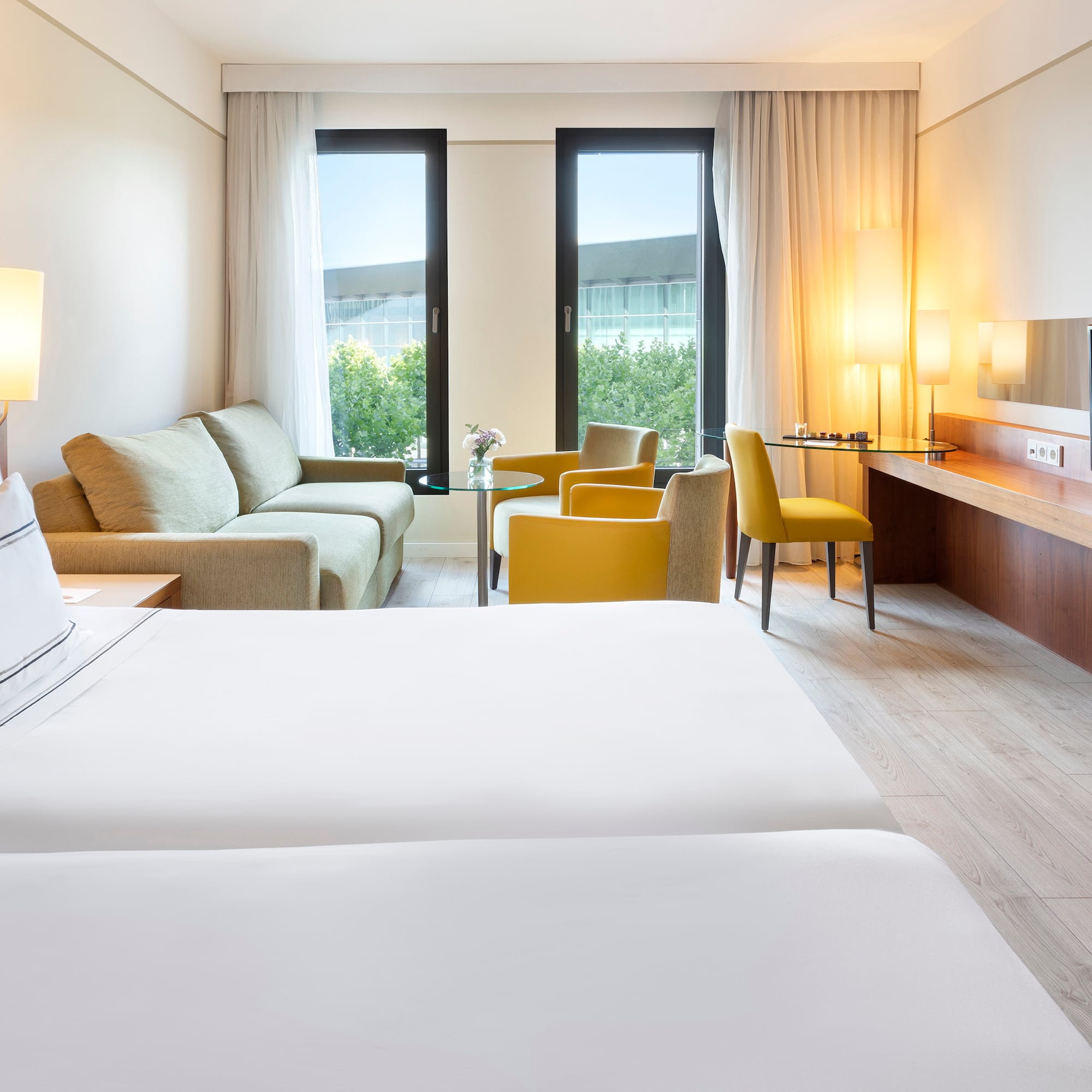 a room with two beds and a television