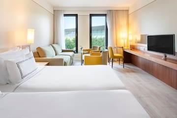 a room with two beds and a television