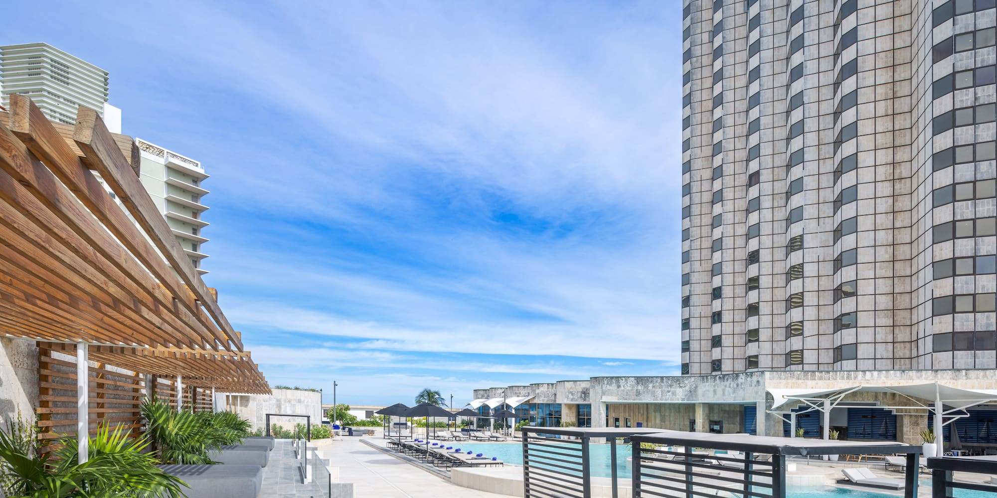 a pool and a building with a pool in the background