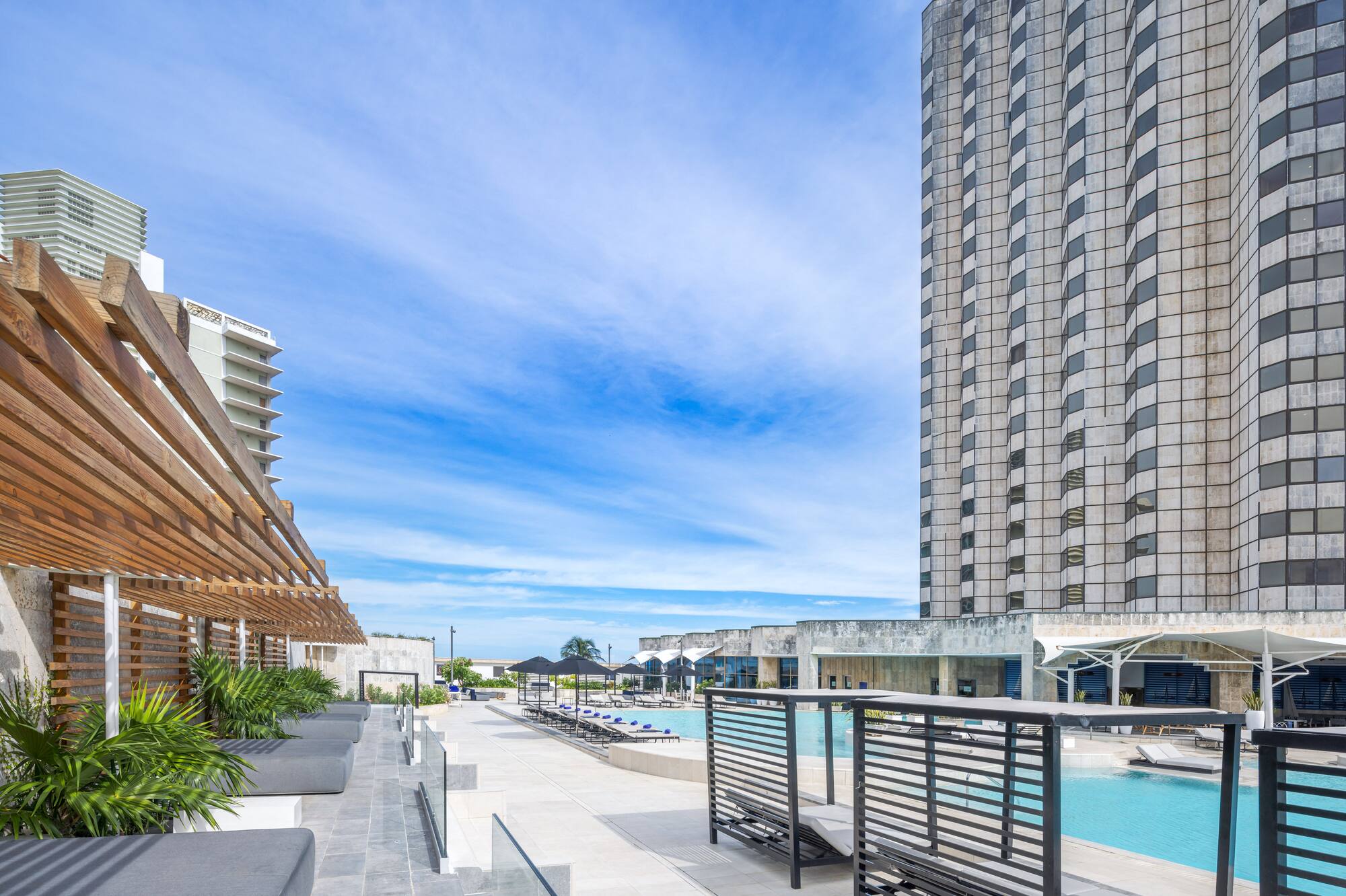 a pool and a building with a pool in the background
