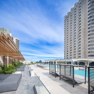 a pool and a building with a pool in the background