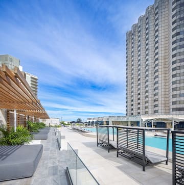 a pool and a building with a pool in the background