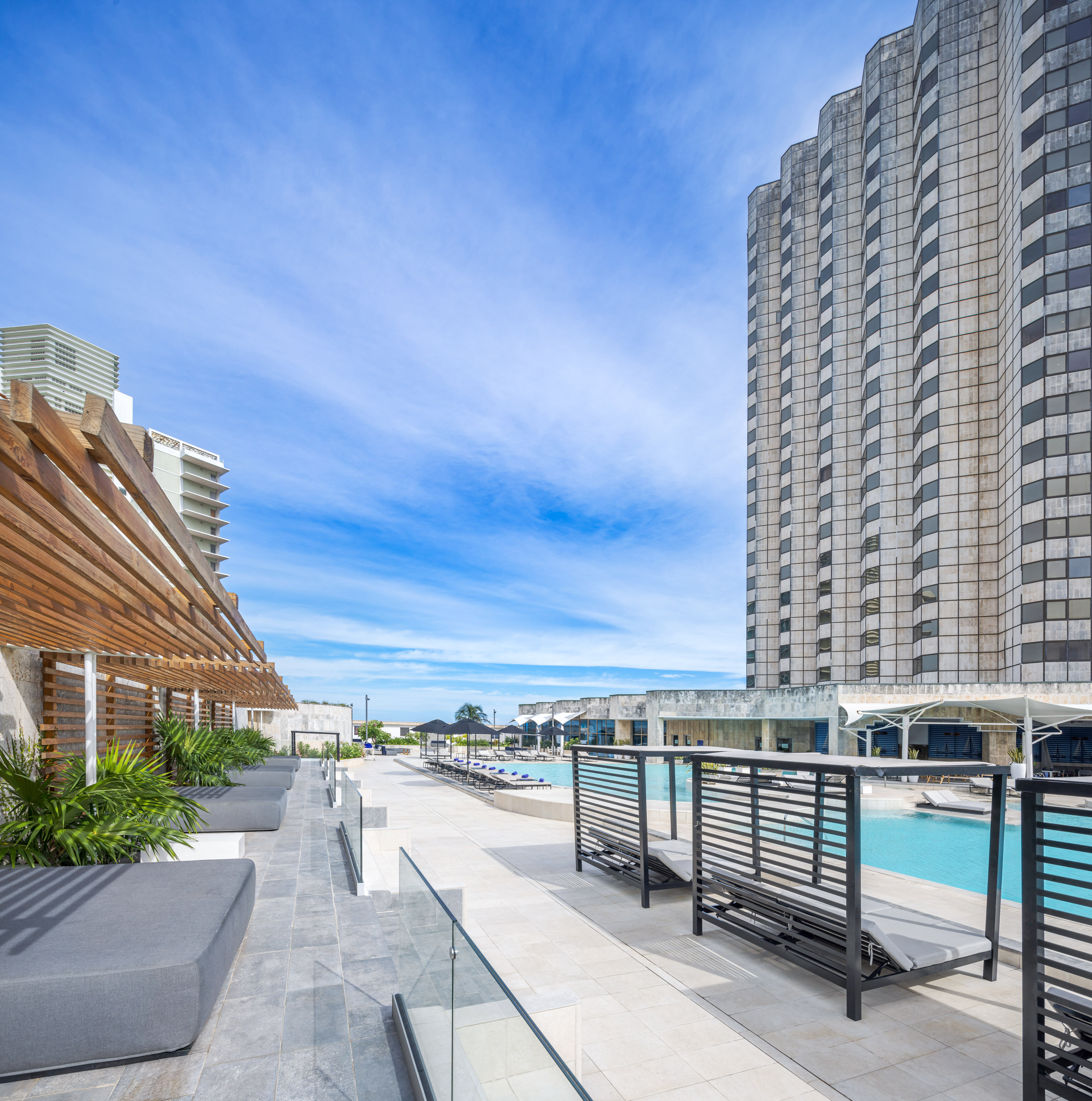 a pool and a building with a pool in the background