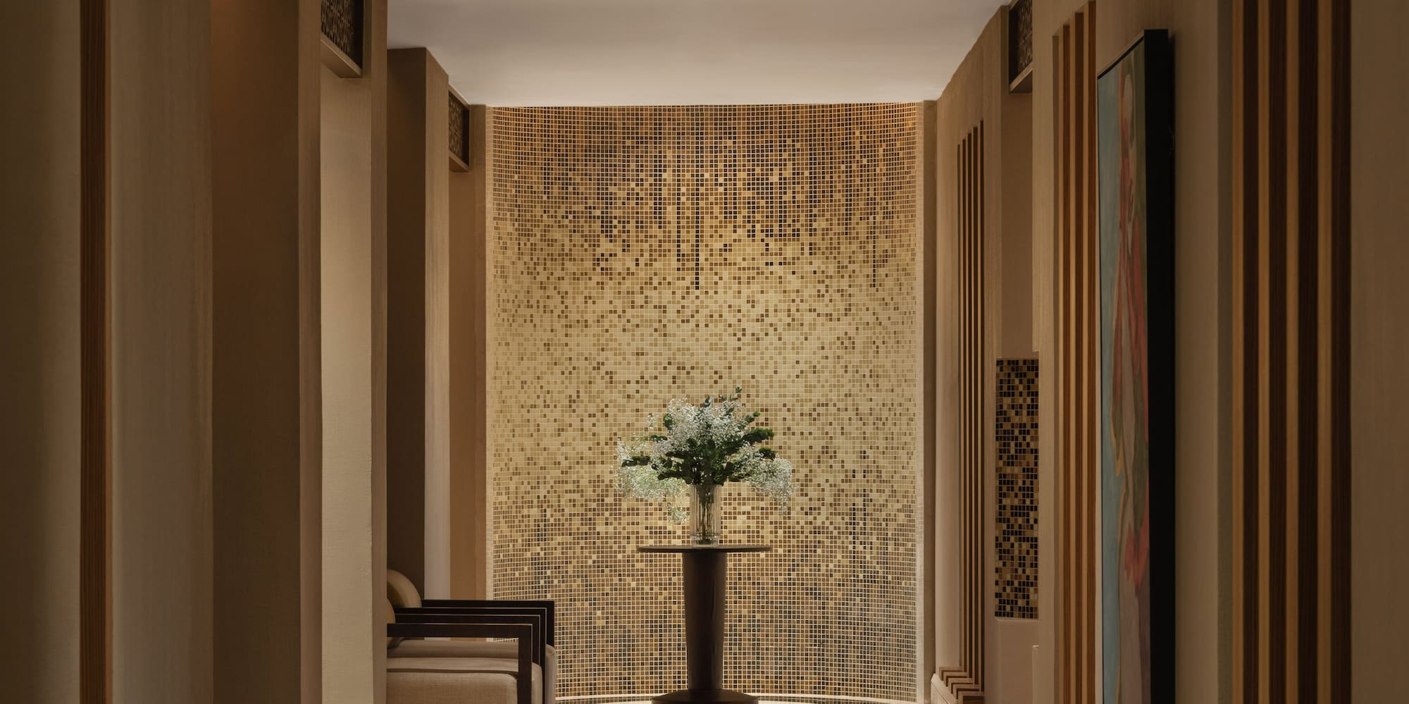 a hallway with a vase of flowers