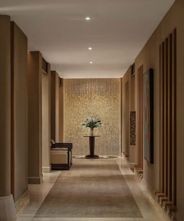 a hallway with a vase of flowers