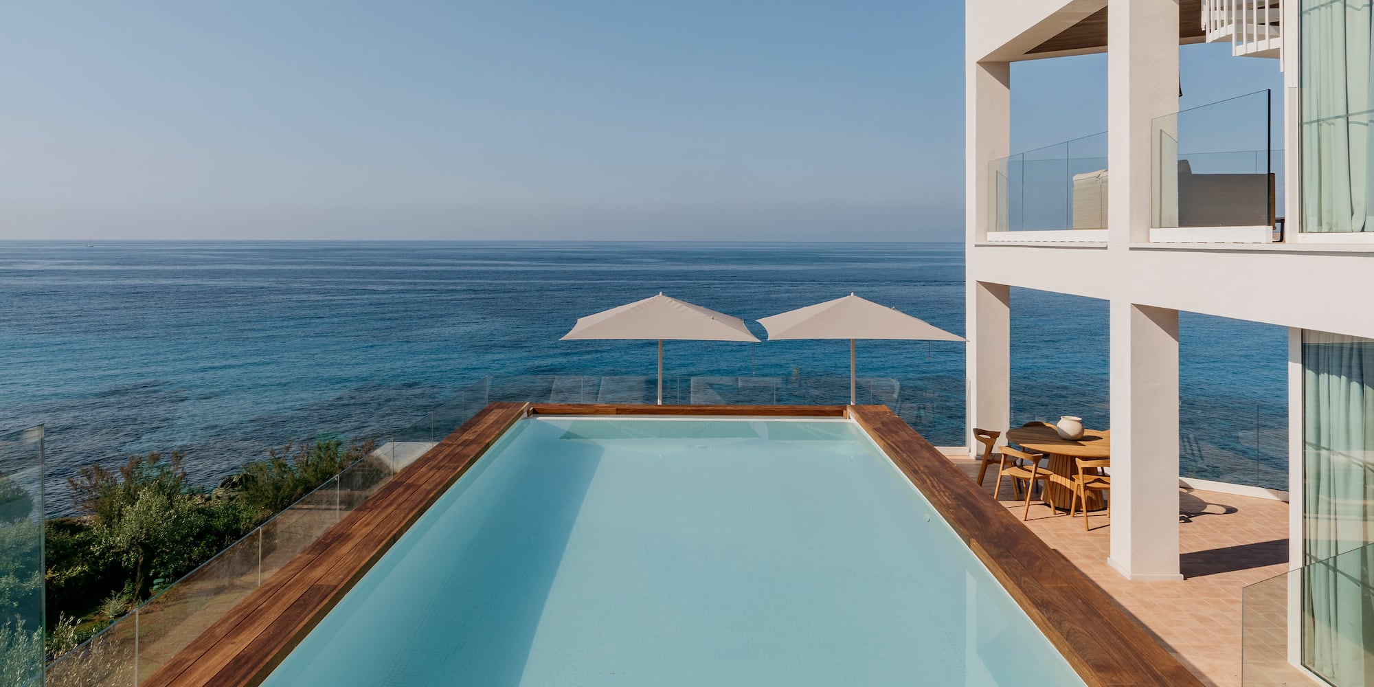 a pool with a deck overlooking the ocean