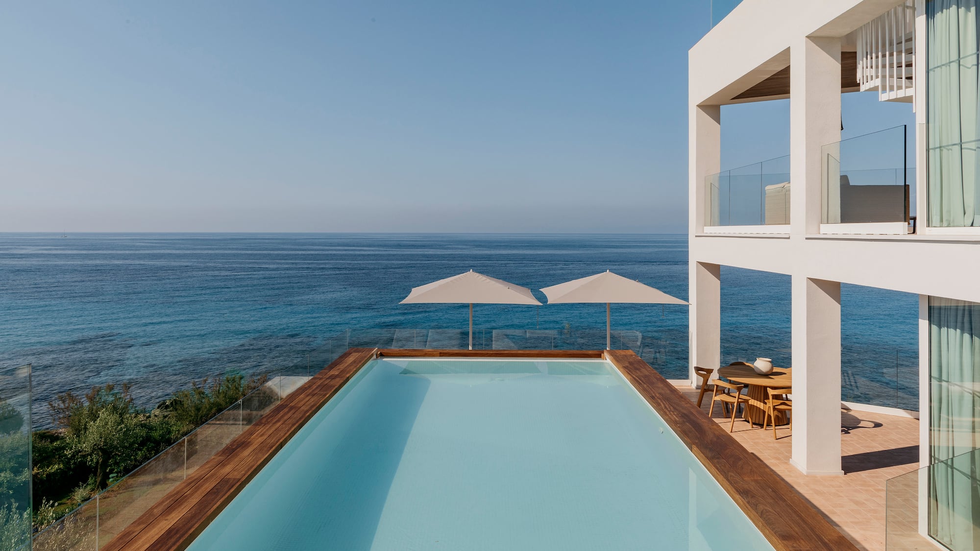 a pool with a deck overlooking the ocean