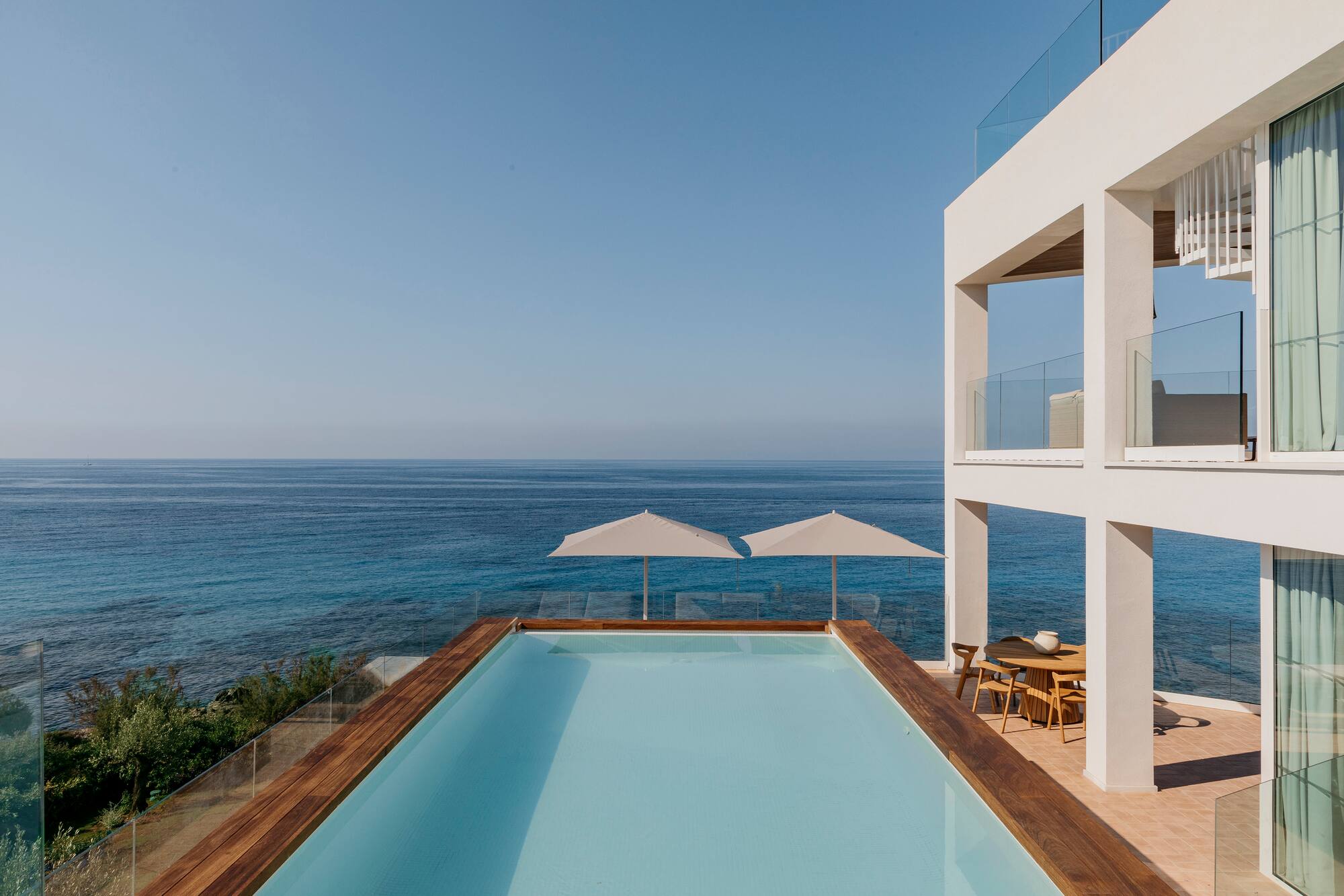 a pool with a deck overlooking the ocean
