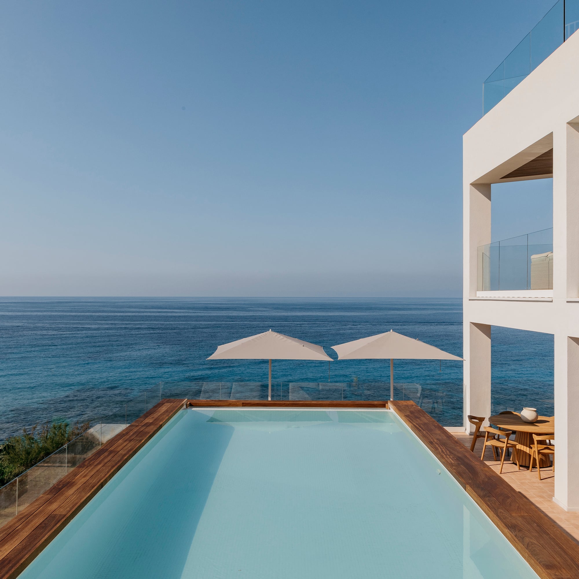 a pool with a deck overlooking the ocean