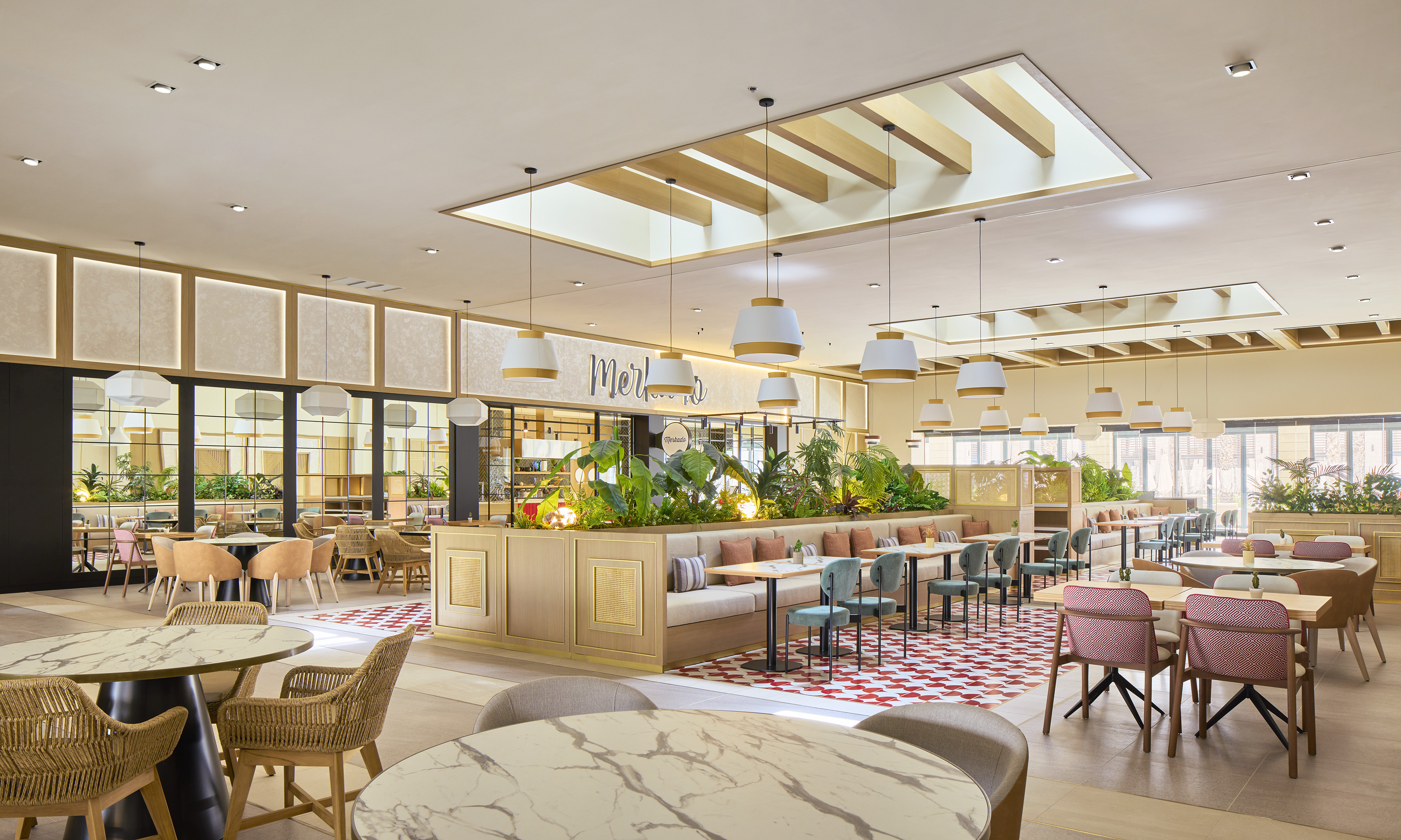 Modern restaurant interior with diverse seating, plants, and natural light.