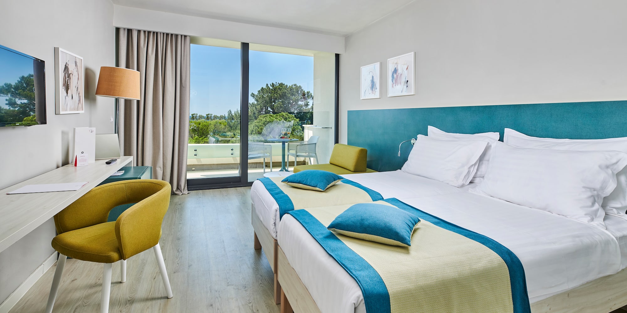 a room with two beds and a desk