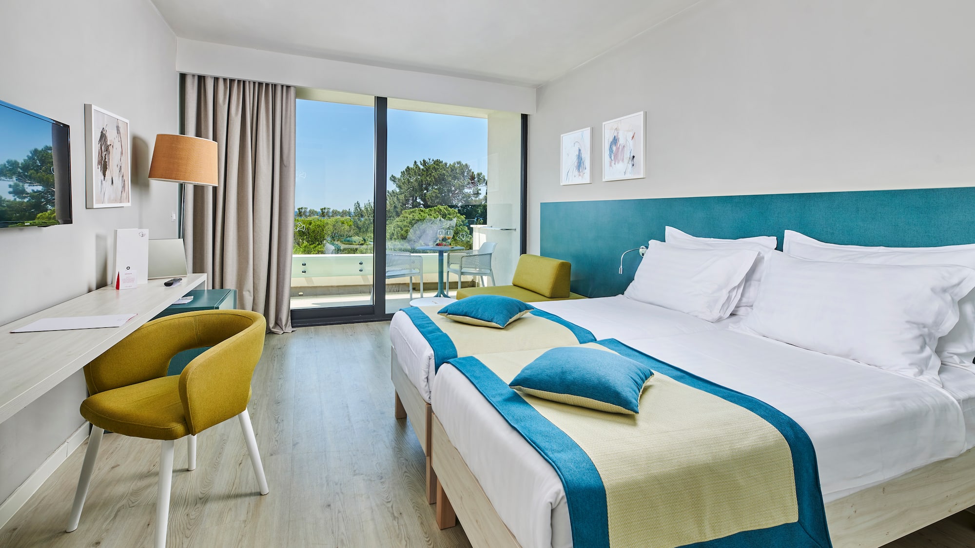 a room with two beds and a desk