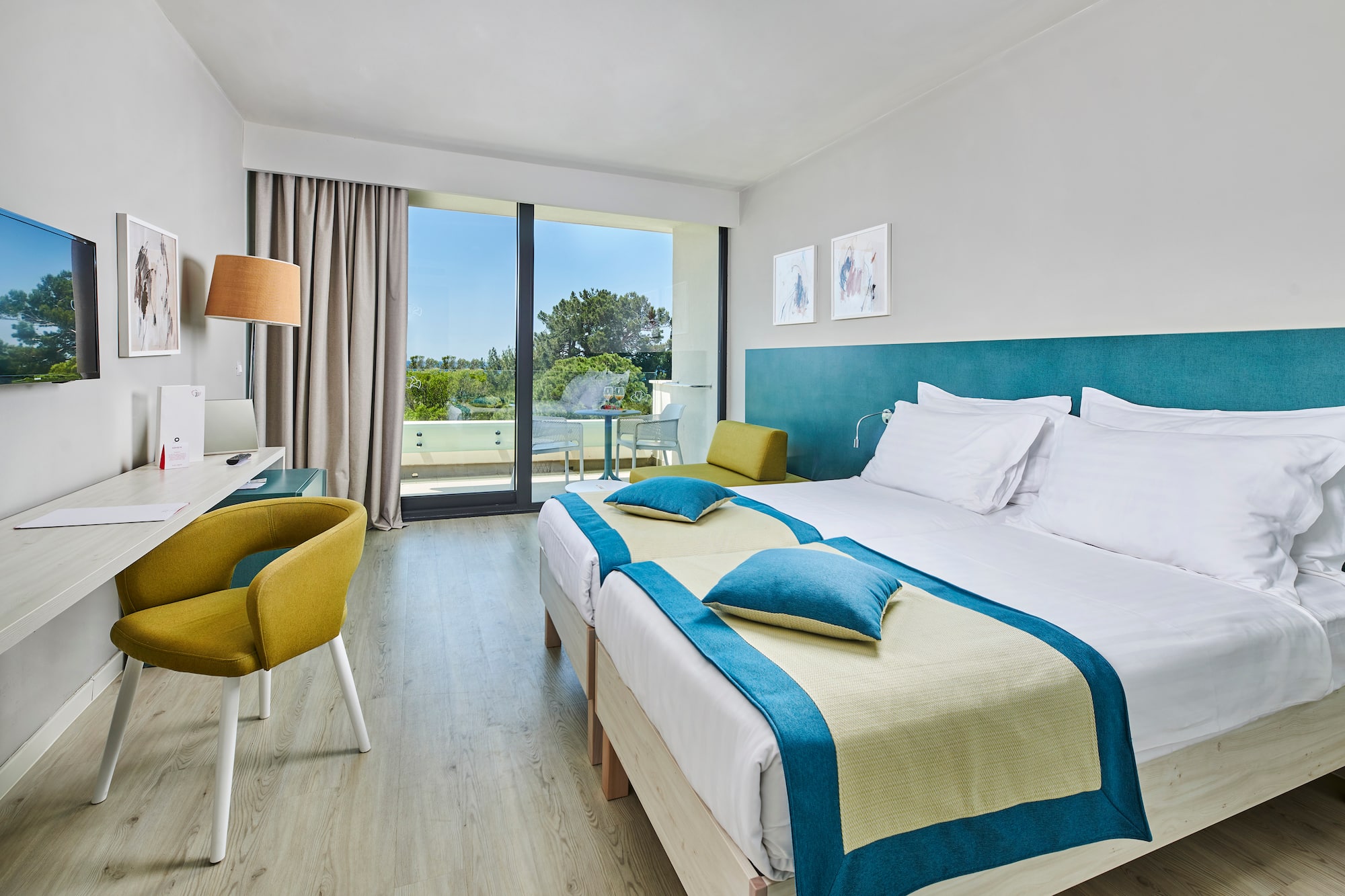 a room with two beds and a desk