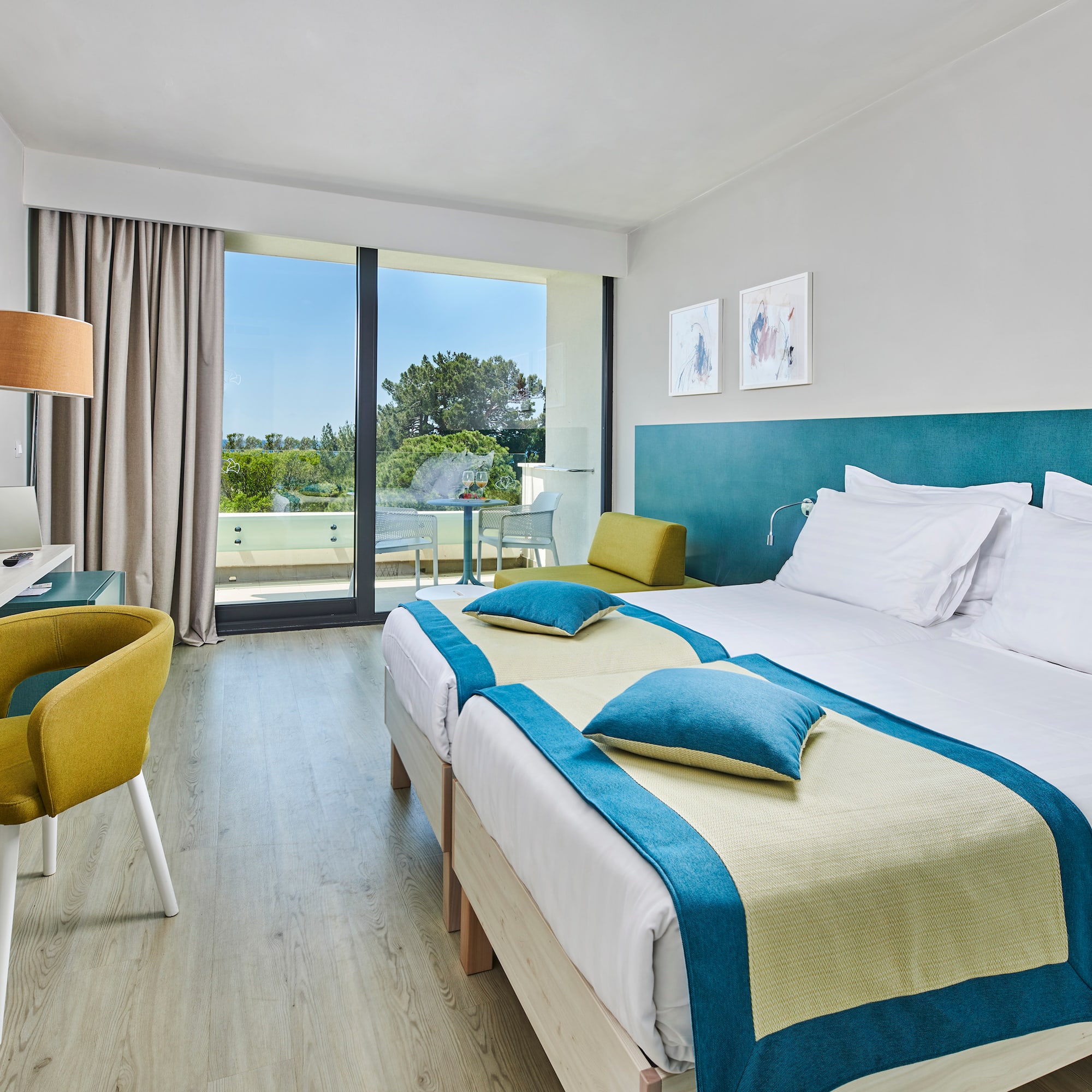 a room with two beds and a desk