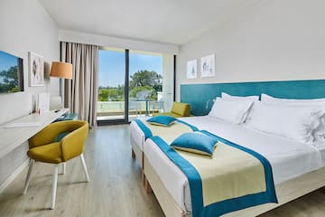 a room with two beds and a desk