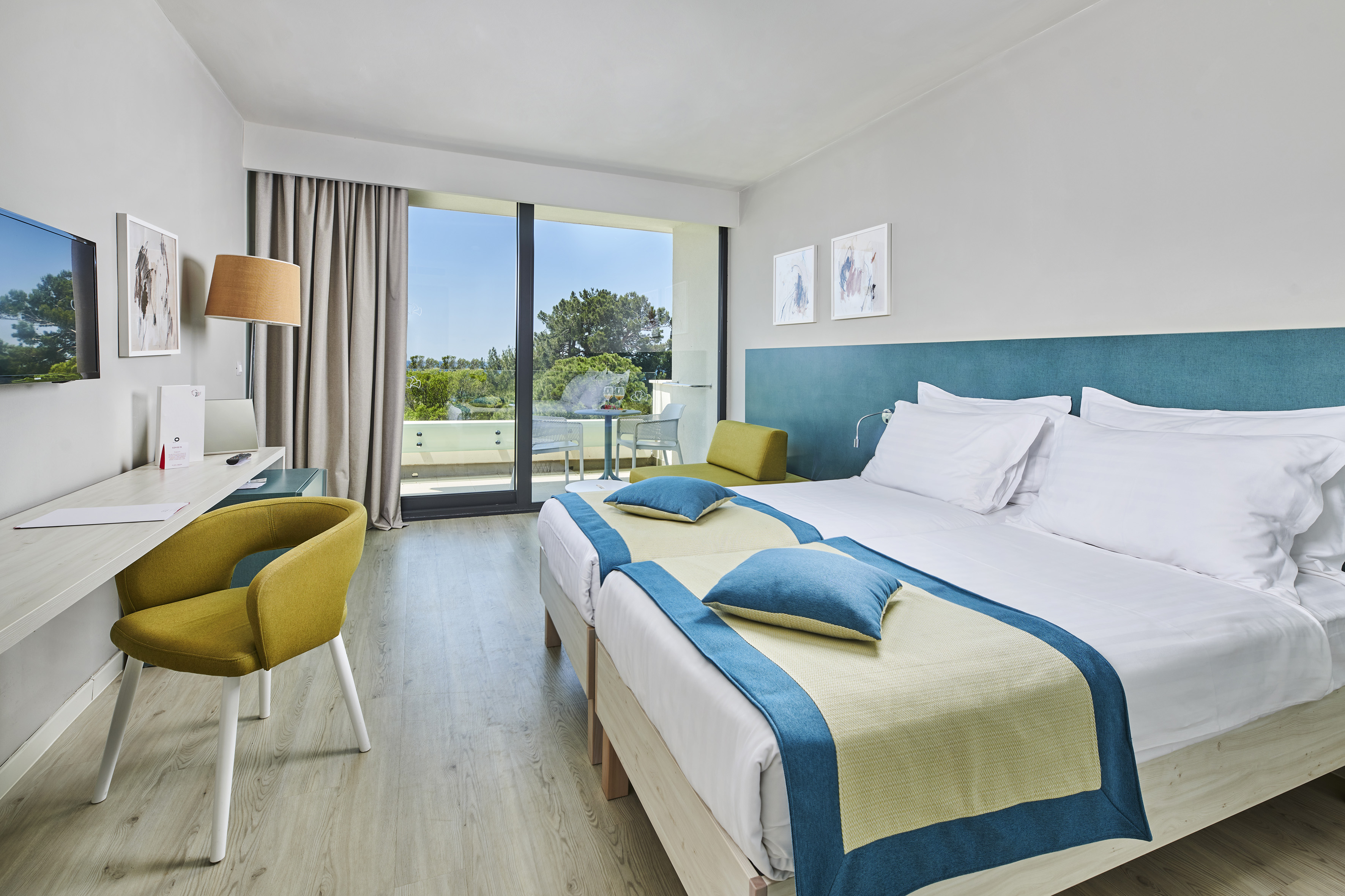 a room with two beds and a desk