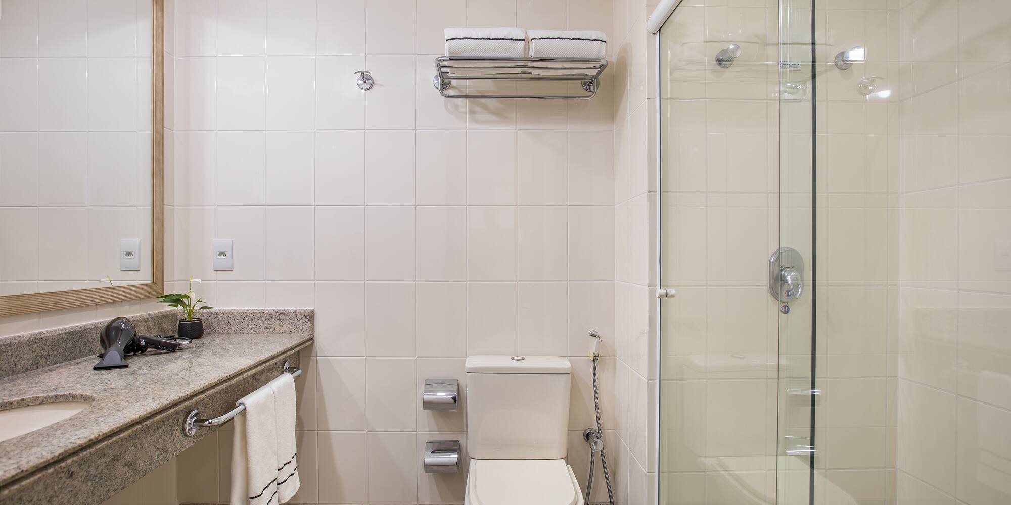 a bathroom with a glass shower and toilet