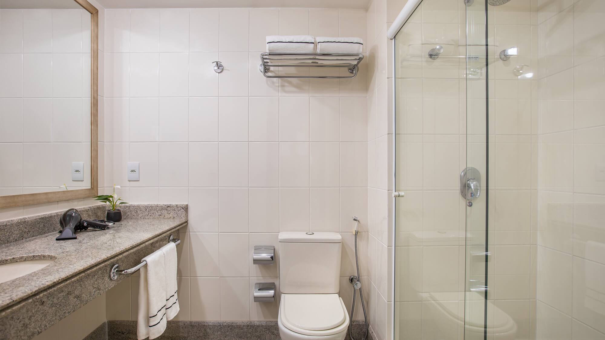 a bathroom with a glass shower and toilet