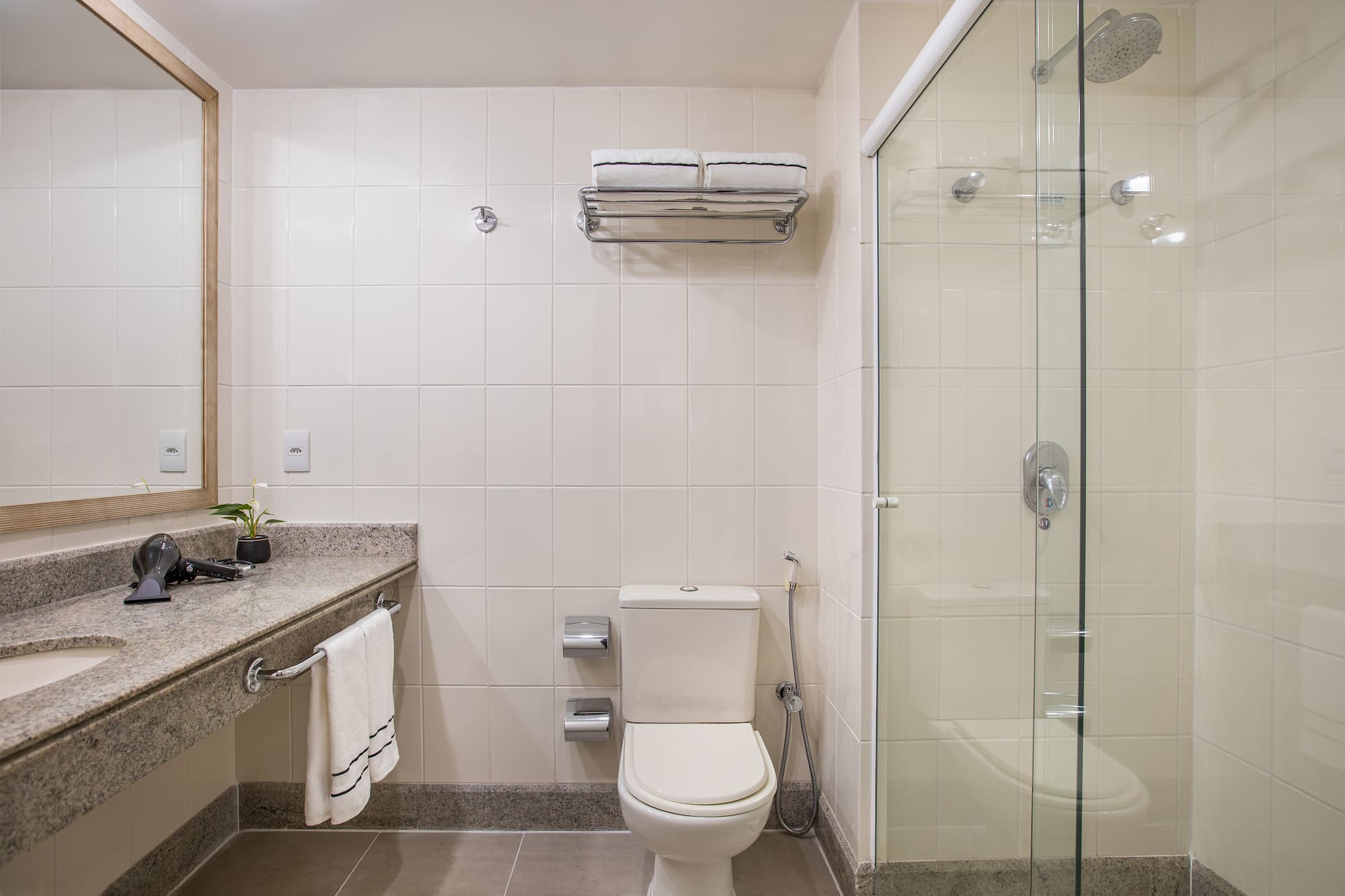 a bathroom with a glass shower and toilet