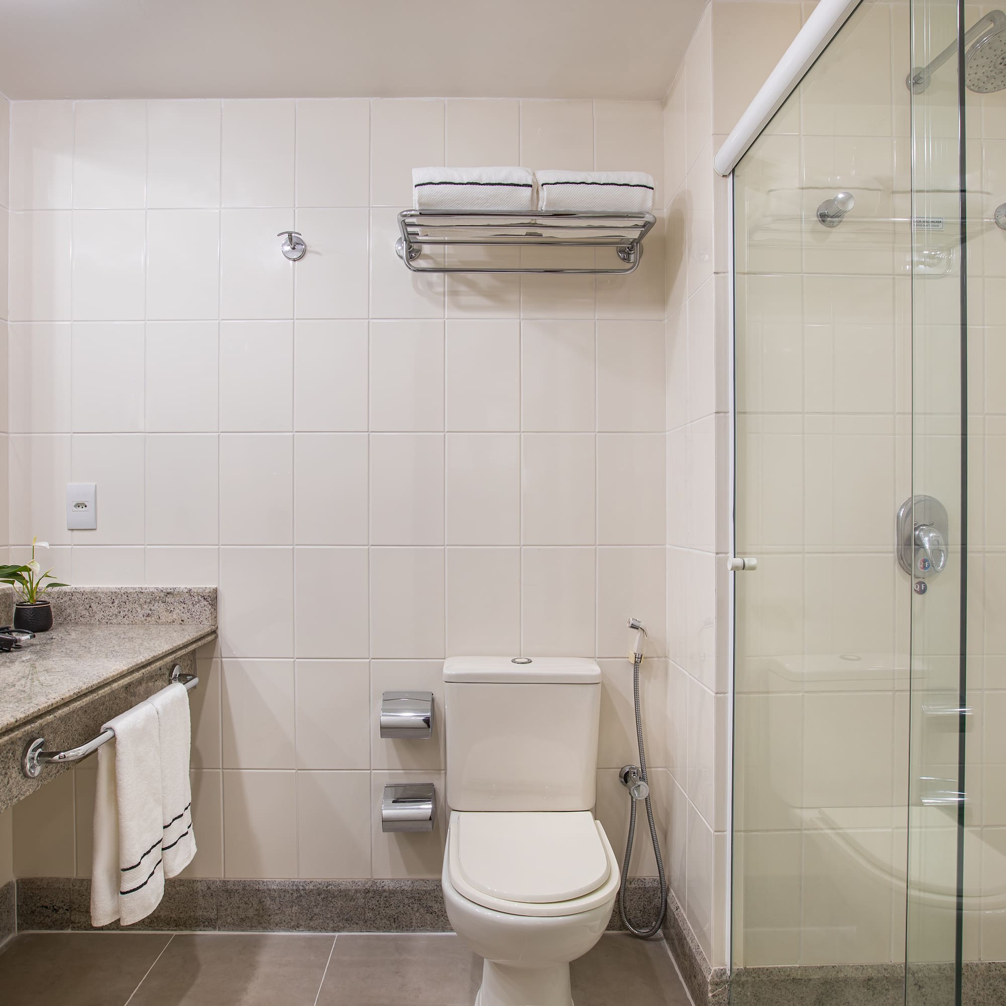 a bathroom with a glass shower and toilet