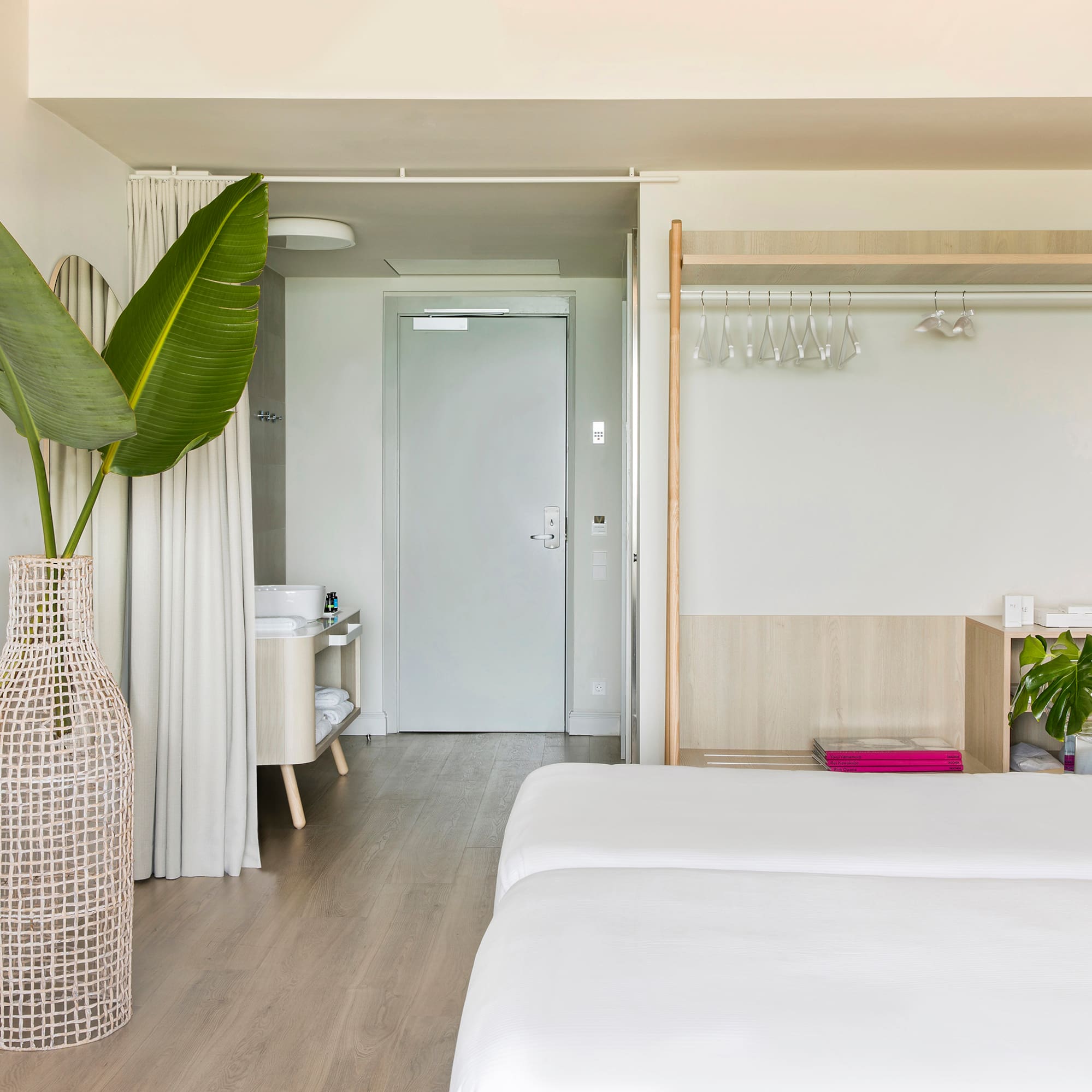 a room with a large plant in a vase