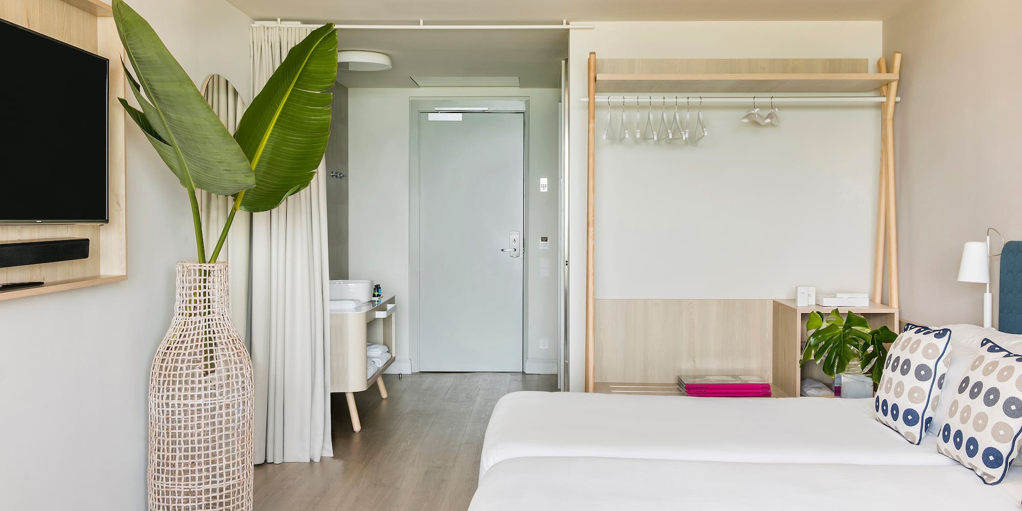 a room with a large plant in a vase