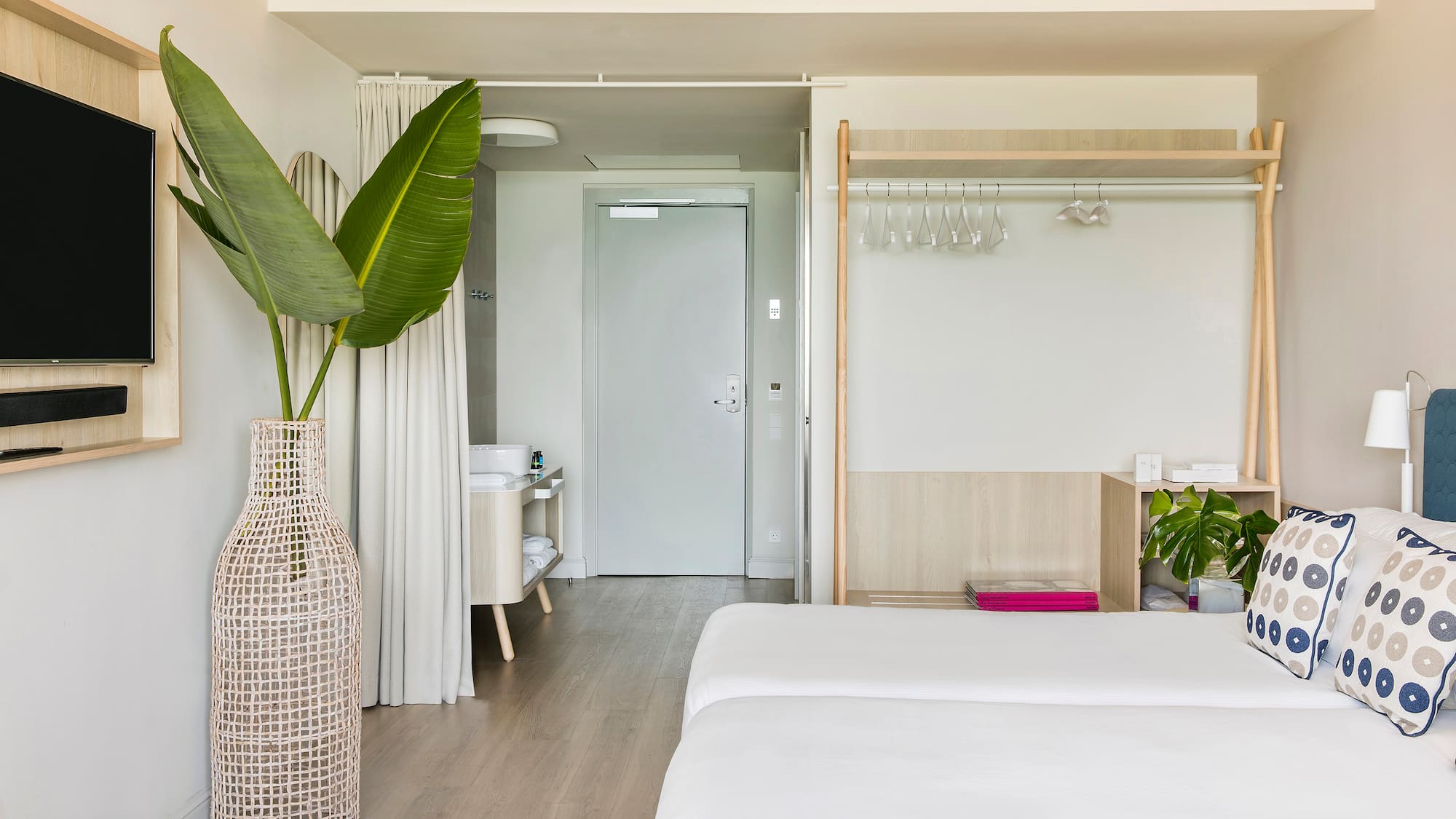 a room with a large plant in a vase