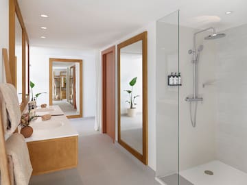a bathroom with double sinks and a shower