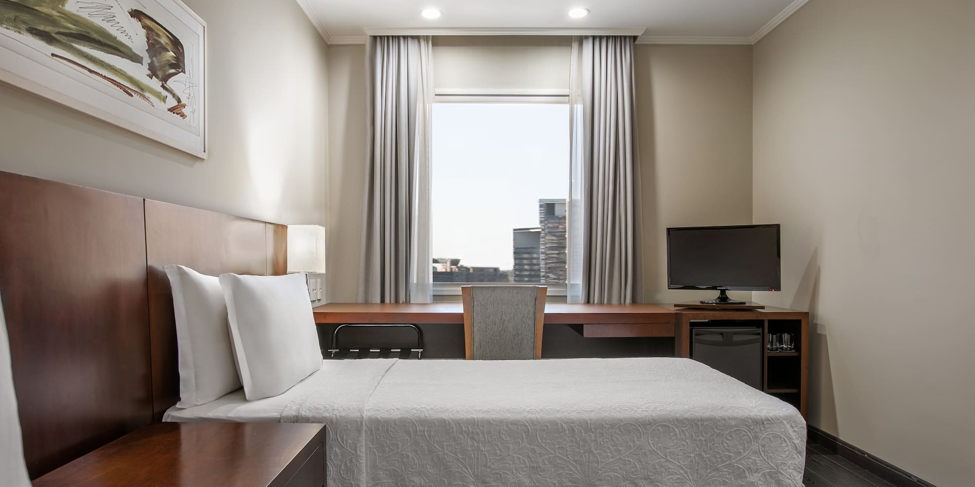 a room with a bed and a desk