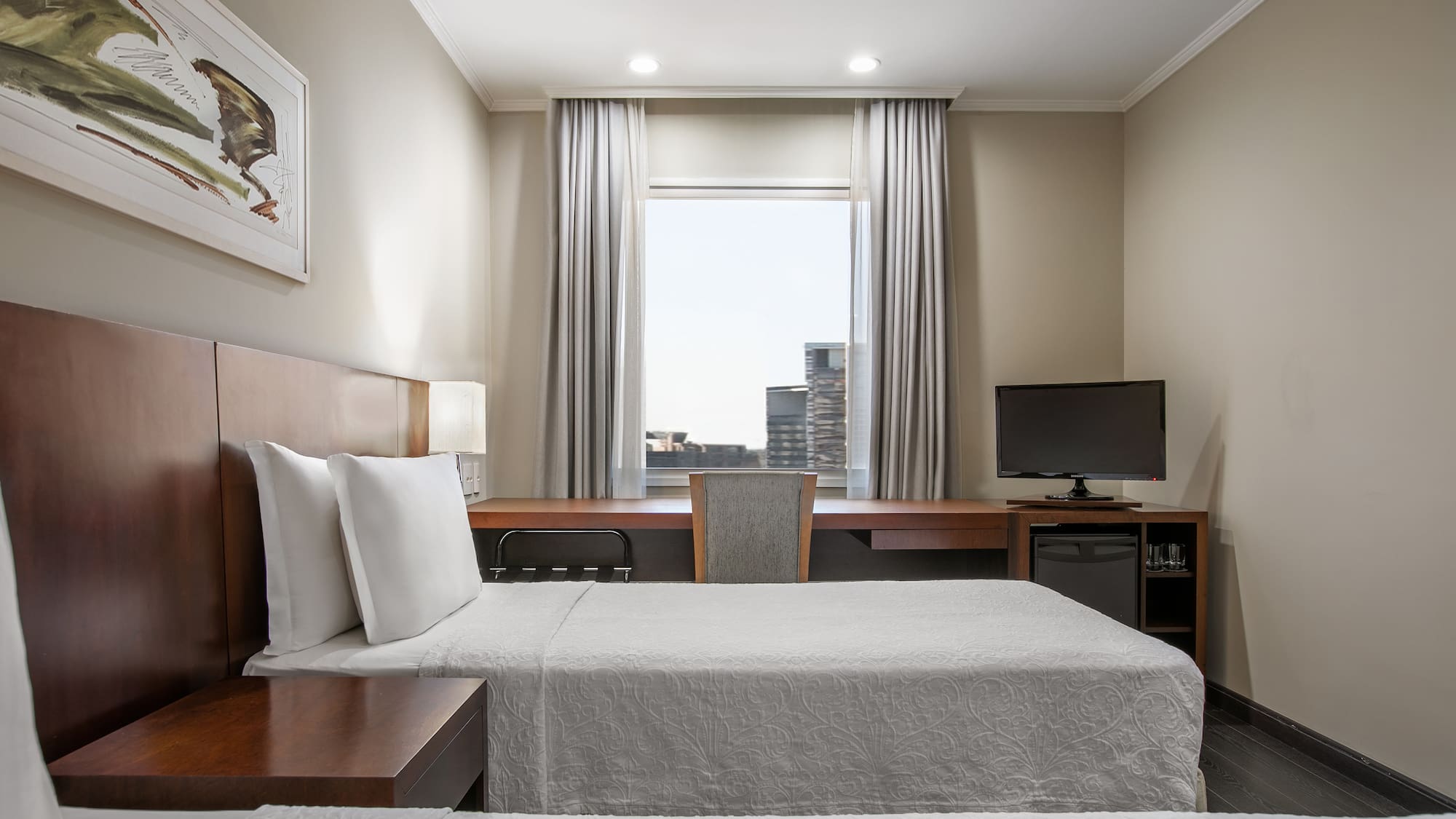 a room with a bed and a desk