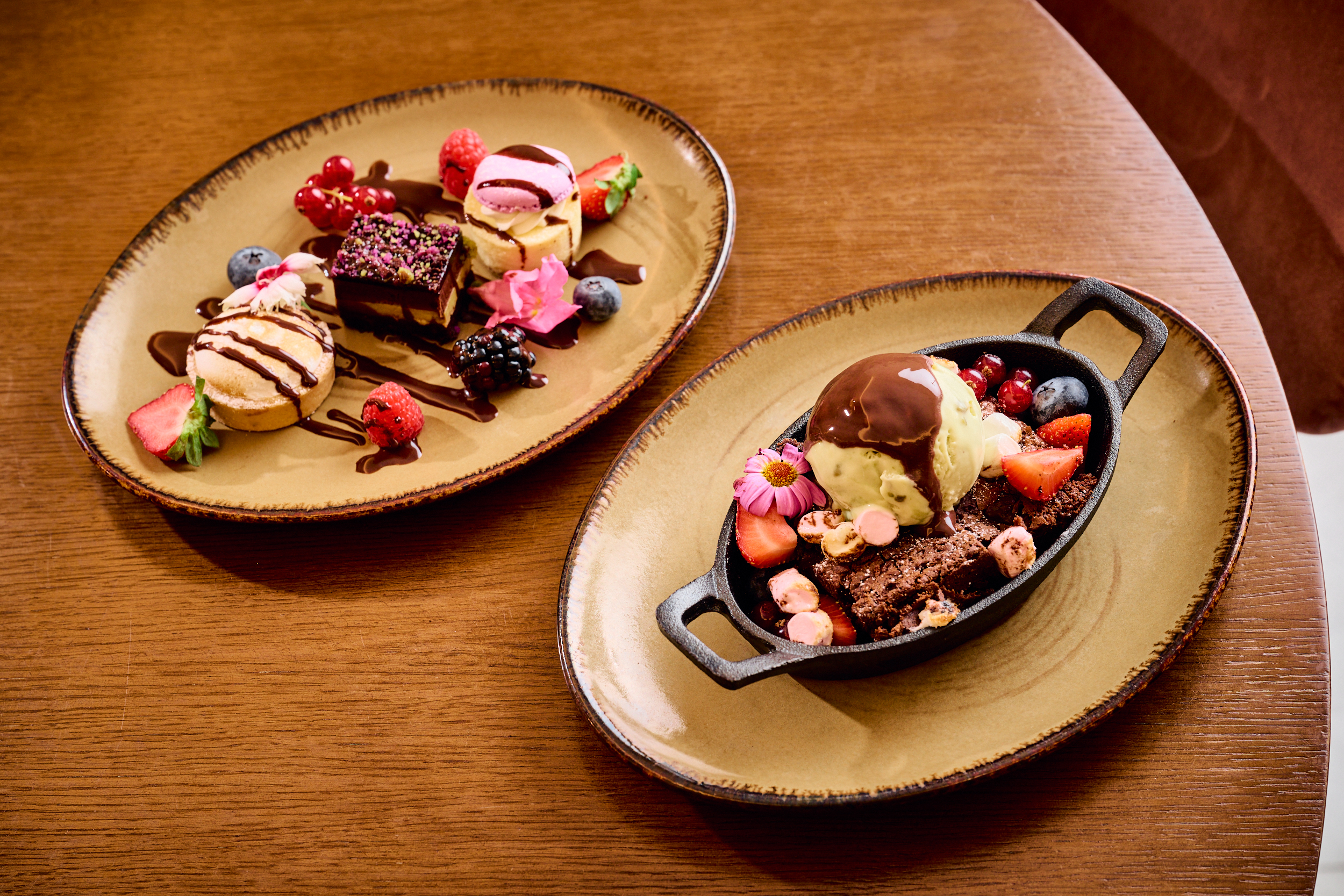 Assorted gourmet desserts: mini cakes, brownie with ice cream, berries, chocolate.