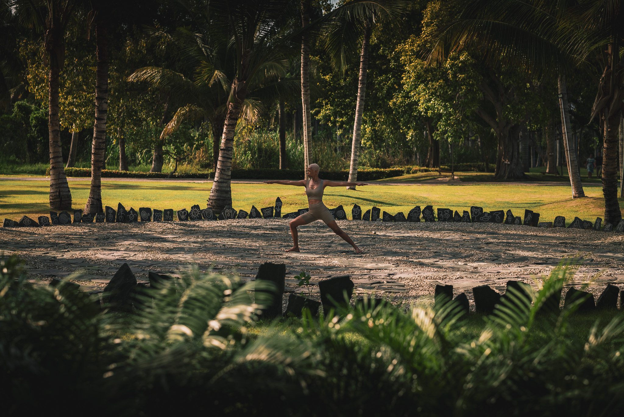 a woman in a garment doing yoga in a park