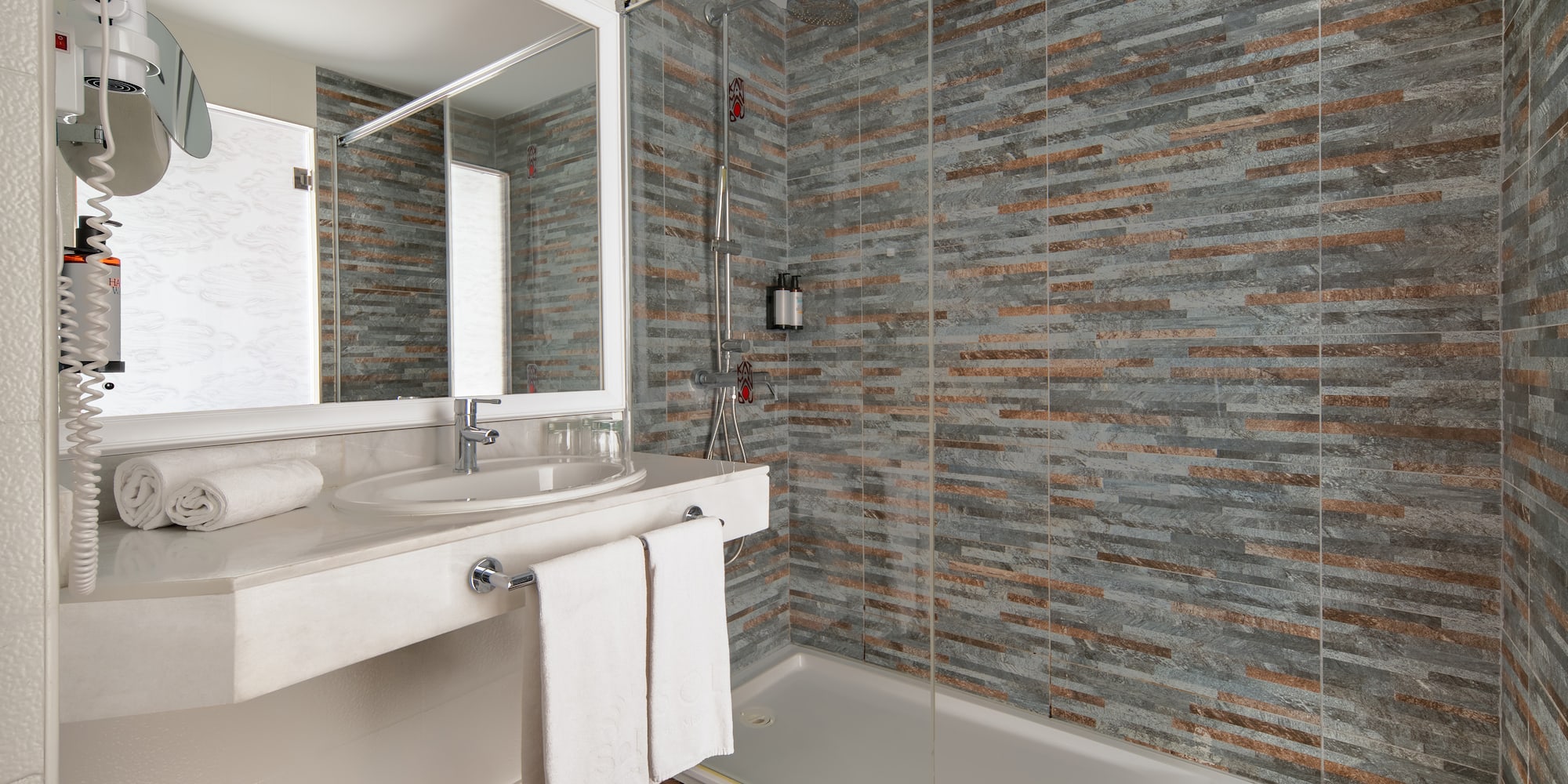 a bathroom with a shower and sink