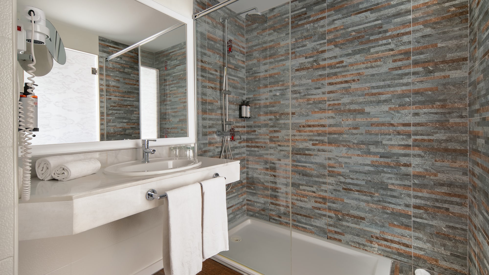 a bathroom with a shower and sink