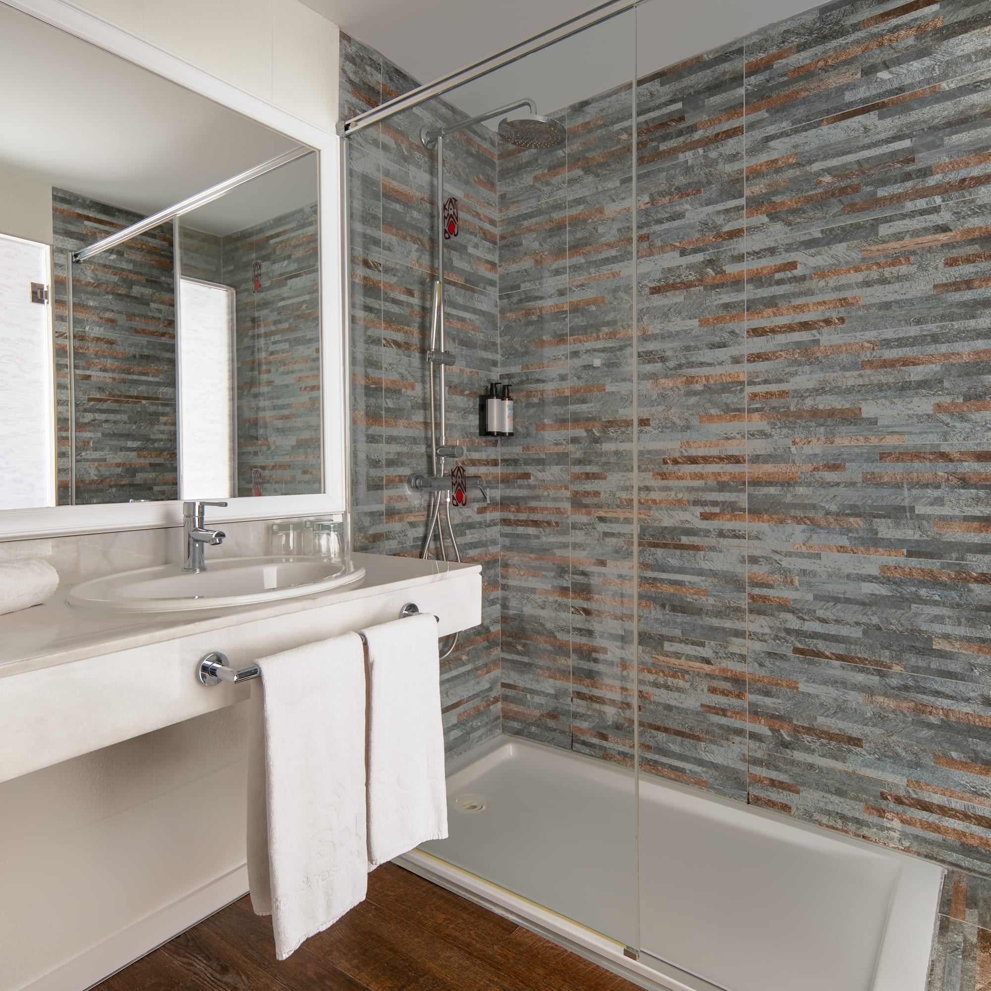 a bathroom with a shower and sink