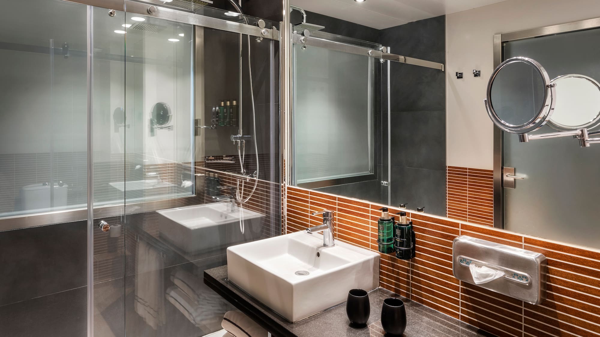 a bathroom with a glass shower door