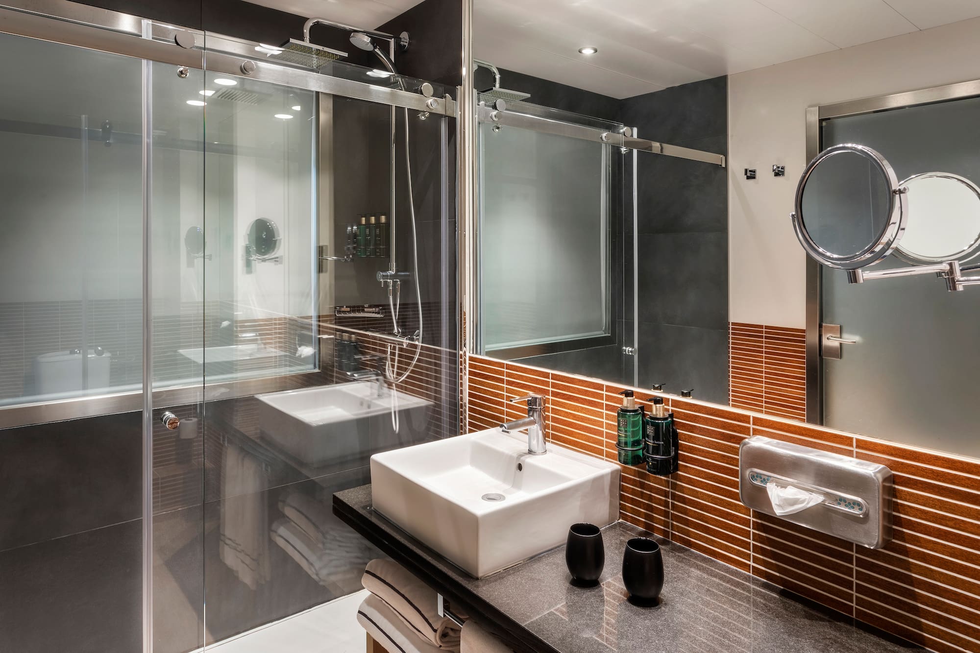 a bathroom with a glass shower door