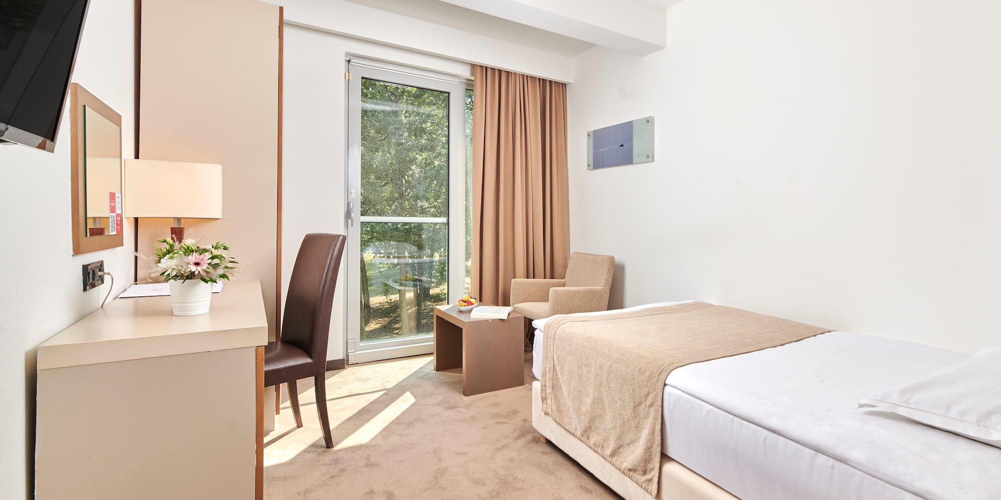 a bedroom with a bed and a desk