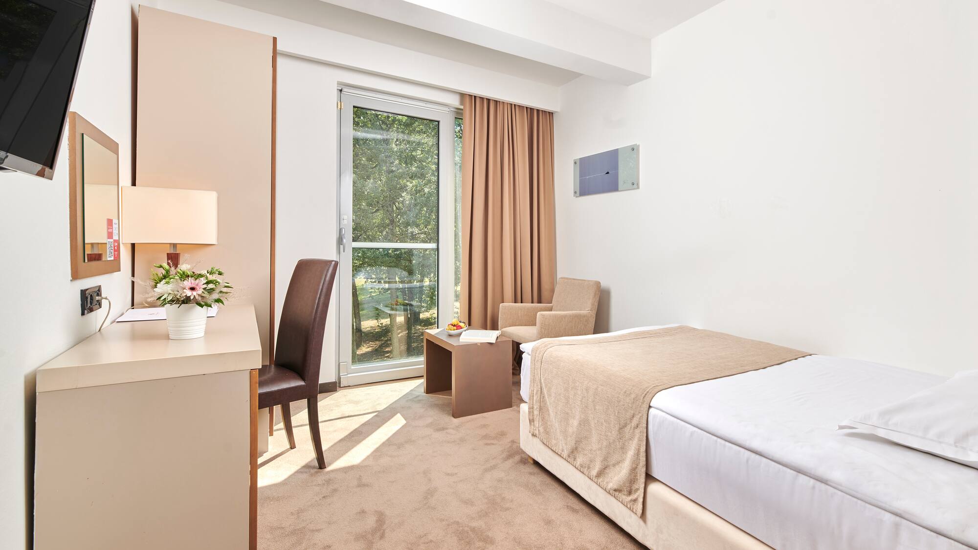 a bedroom with a bed and a desk