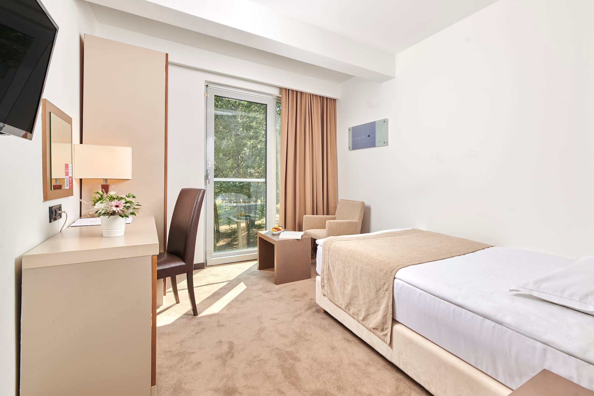 a bedroom with a bed and a desk